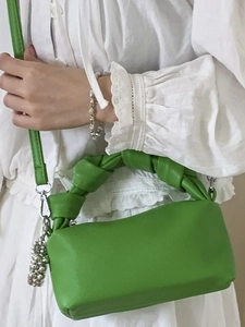 Minimalist green pleated handbag with textured faux leather and adjustable crossbody strap