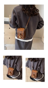 Detail of vintage brown quilted mini bag showing gold hardware and adjustable strap