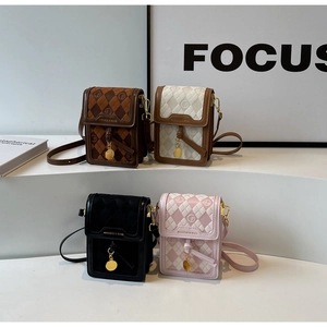 Quilted mini crossbody phone bags with gold charms displayed on a white geometric stand