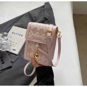 Detail of pink and white checkered mini crossbody bag with gold logo and PU leather texture