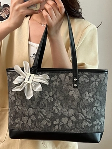 Large capacity floral jacquard tote bag with black leather trim shown in mirror selfie