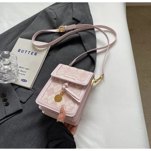 Detail of pink checkerboard crossbody phone bag with quilted PU leather and gold pendant