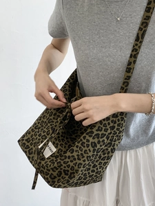 Chic leopard print canvas tote bag with crossbody strap for casual daily styling