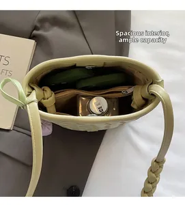 Top view showing spacious interior with zipper pocket and quilted green woven texture