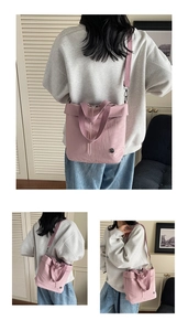 Detail of dusty pink nylon tote bag with drawstring and wide fabric strap in home setting