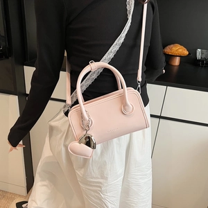 Close-up of pink PU leather bowling bag with heart charm and GLIARCIK embossing