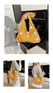 Detail of yellow handmade crochet shoulder bag featuring colorful 3D floral embroidery