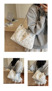Detail view of white quilted chain bag with rhinestone star and silver metallic hardware