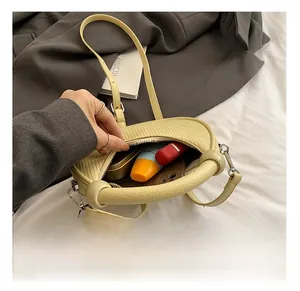 Detail view of lychee texture handbag interior showing storage capacity for essentials