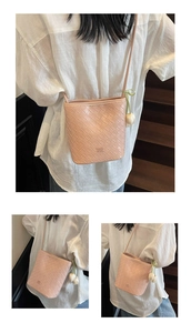 Detailed woven bucket bag in nude pink with a delicate tulip charm and logo detail