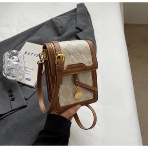 Close-up of vintage monogram mini crossbody bag with golden hardware and brand logo