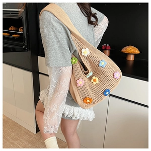 Close-up of handmade crochet tote bag with colorful 3D flower knits and hollow design