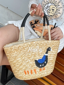 Straw beach tote with embroidered duck and Hello lettering for summer vacation