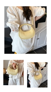 Detail of light yellow woven half-moon handbag with top handle and detachable shoulder strap