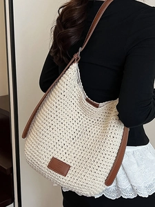 Large woven cotton shoulder bag with leather straps and minimalist bucket style design