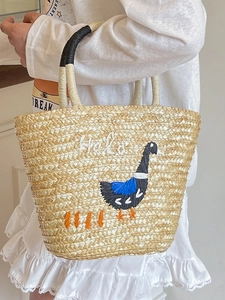Handmade straw beach tote with swan embroidery and Halo text for summer beach vacation