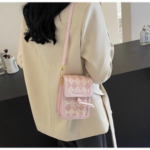 Detail of pink and white checkered mini crossbody bag with gold logo and shoulder strap
