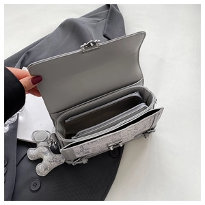 Close-up of the gray floral jacquard bag interior featuring a silver metal zipper pocket