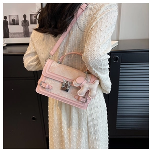 Pink quilted shoulder bag featuring retro silver lock and cute puppy plush pendant charm