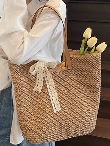 Large woven straw tote bag with lace bow and leather straps for summer beach style