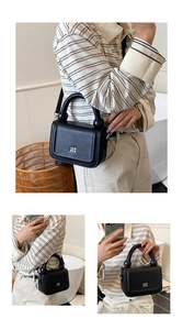 Detail view of black lychee grain leather crossbody bag with metal logo and unique handle