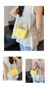 Detail view of a lemon yellow pebbled leather bag with a unique gold sphere handle detail
