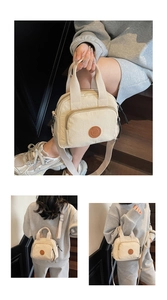 Detail of a beige mini crossbody bag with a round leather patch and adjustable wide strap