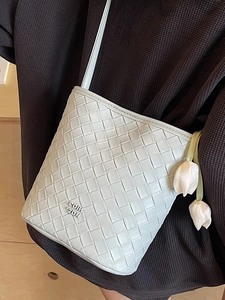 Fashion woven mint green leather crossbody bag with flower charm and logo detail