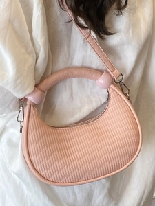 Pink crescent handbag with vertical stripe texture and silver hardware in a stylish look
