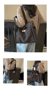 Detail view of large black canvas tote bag with functional side drawstring pockets