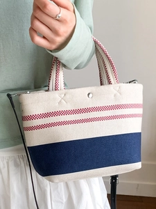 Minimalist canvas bucket tote bag with red and blue stripes and leather strap