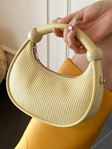 Minimalist light yellow pleated leather crescent handbag with unique sphere accents