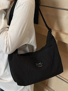 Minimalist black large capacity crossbody tote bag with stylish white text patch for women