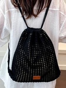 Chic black crochet drawstring backpack with woven mesh texture and faux leather patch