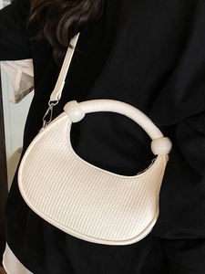 White semi-circle handbag with vertical stripes, ring handle and large sphere ornaments