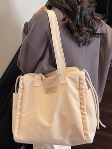 Minimalist beige canvas tote bag for women with large capacity and stylish side pleats