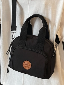 Chic black nylon crossbody bag with adjustable shoulder strap and top handle for women