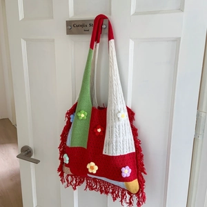 Handmade crochet patchwork tote bag with colorful flower patterns and red tassels