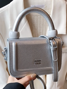 Silver textured mini crossbody bag with round handle and grey spherical decor details