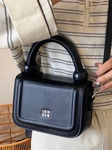 Fashionable black pebble leather underarm bag with silver chain and metal clasp detail
