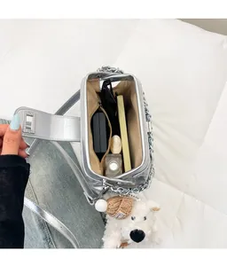 Interior view of quilted silver bag showing spacious capacity with sunglasses and makeup