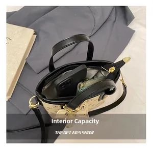 Detail view of the spacious inner compartment with zip pocket for beige bucket bag