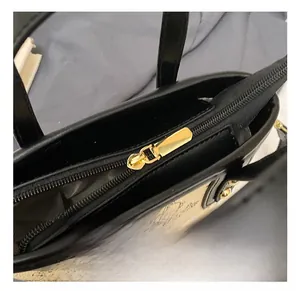 Detail shot of the premium golden metal zipper and retro printed leather texture