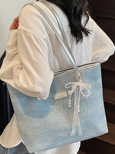 Light blue glitter tote bag with silver leather straps and pearl bow charm accessory