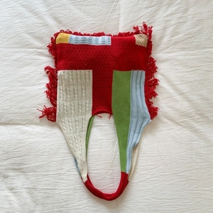 Detailed knit texture and vibrant colorful color-block splicing with red fringe tassels