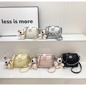 Quilted diamond lattice crossbody bags in five colors with cute puppy charms on display