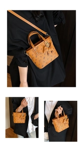 Detail of tan leather tote bag with bear patterns, bow charm and adjustable shoulder strap