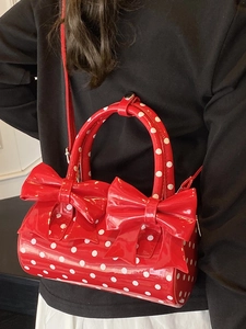 Sac à main cylindrique à pois avec grands nœuds rouges et bandoulière amovible