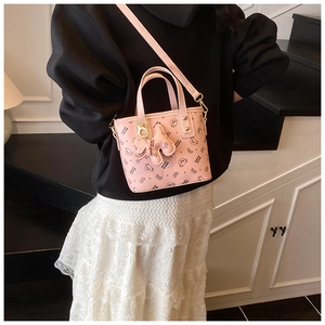 Detail of pink faux leather tote bag with cartoon bear prints and adjustable strap