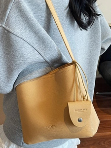 Fashionable retro bucket bag in mustard yellow pebble leather with thin crossbody strap
